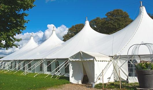 a line of portable restrooms in a shaded area, offering a comfortable experience for users in Horsham